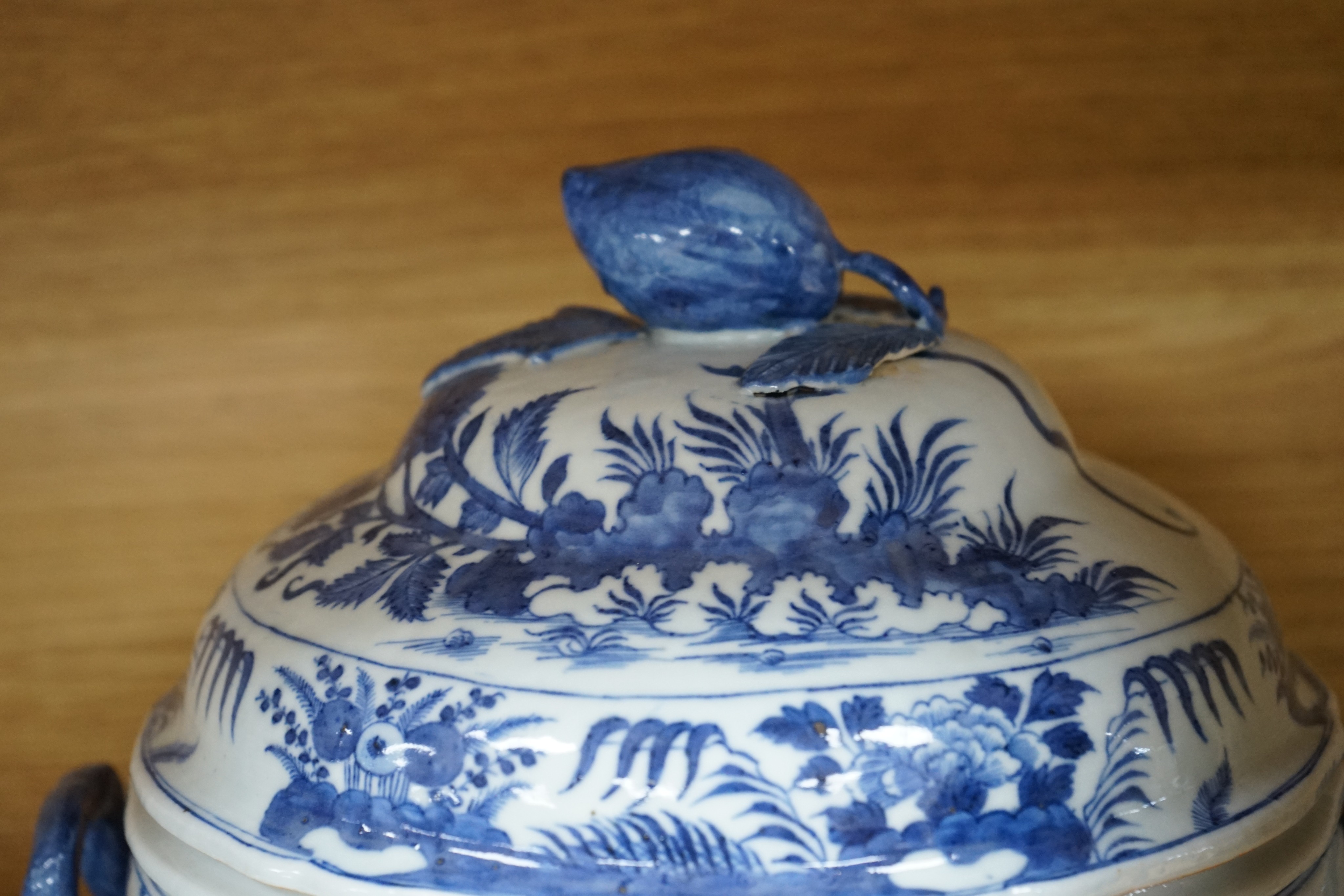 An 18th century Chinese Export blue and white octagonal tureen and cover, decorated with birds and flowers, a pair of similar sauceboats and five plates decorated with urns of flowers